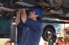 Roberto fixing an exhaust system.