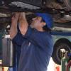 Roberto fixing an exhaust system.